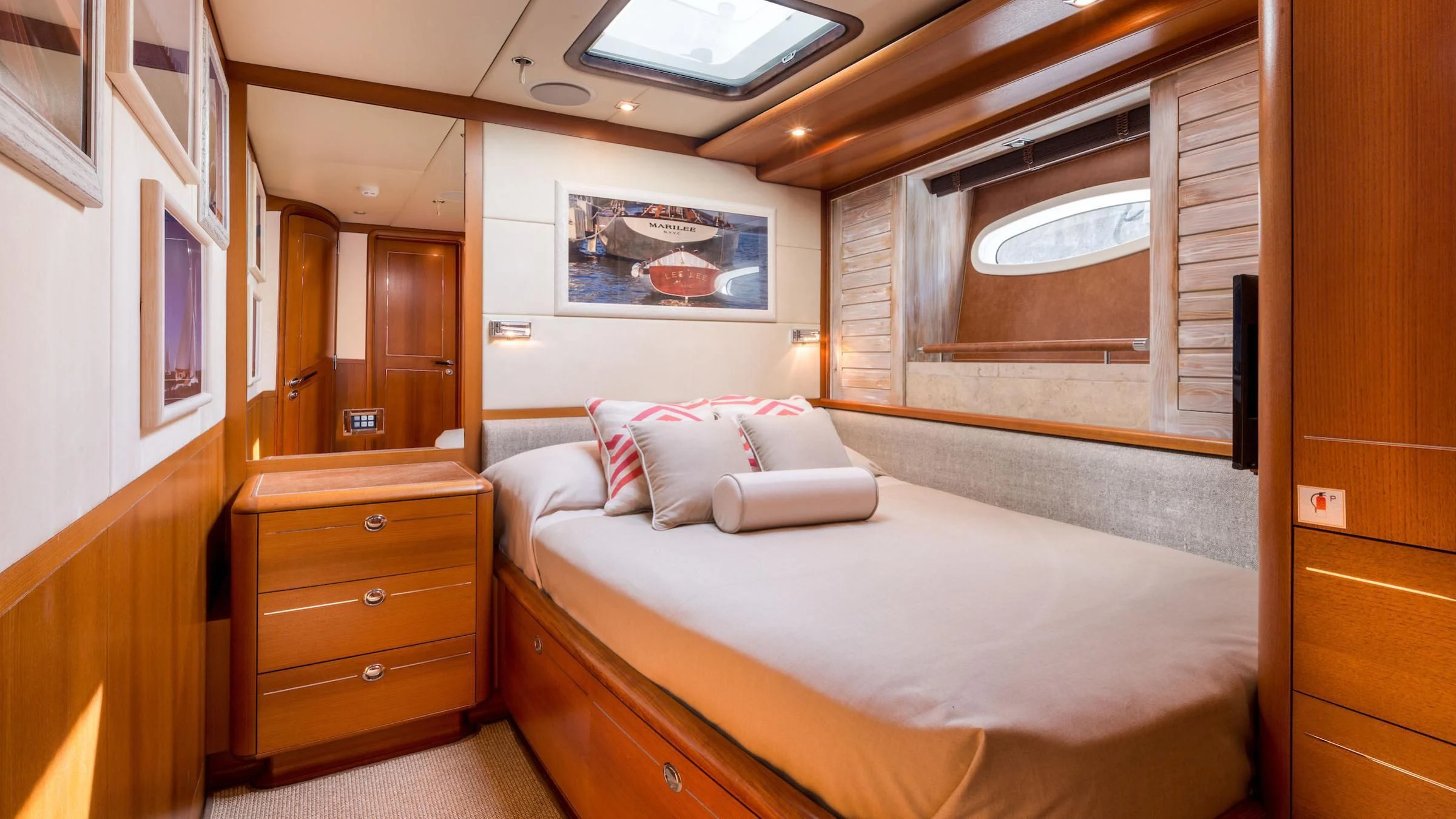 a bedroom with a bed and a dresser aboard DANNESKJOLD Yacht for Sale