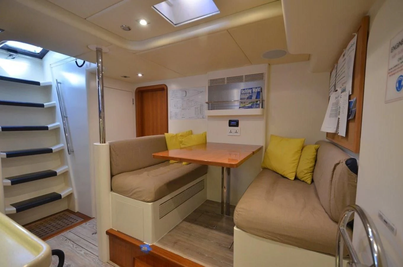 a living room with a desk and a bed aboard DANNESKJOLD Yacht for Sale