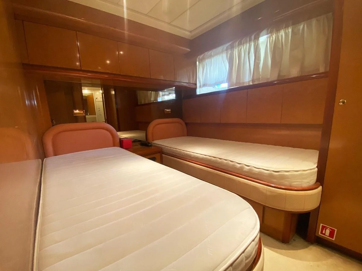 a room with a bed and a chair aboard GRAN FINALE II Yacht for Sale