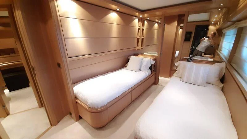 a room with two beds aboard OKAMI Yacht for Sale