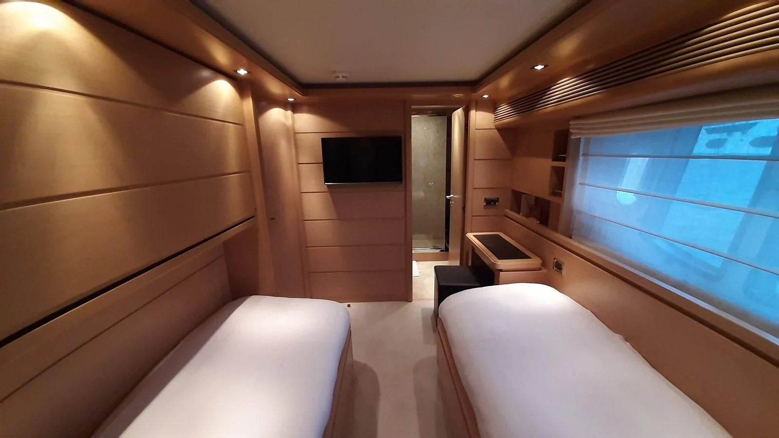 a room with a bed and a window aboard OKAMI Yacht for Sale