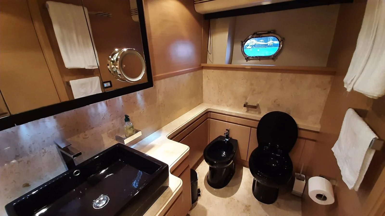 a bathroom with a black countertop and a black chair aboard OKAMI Yacht for Sale