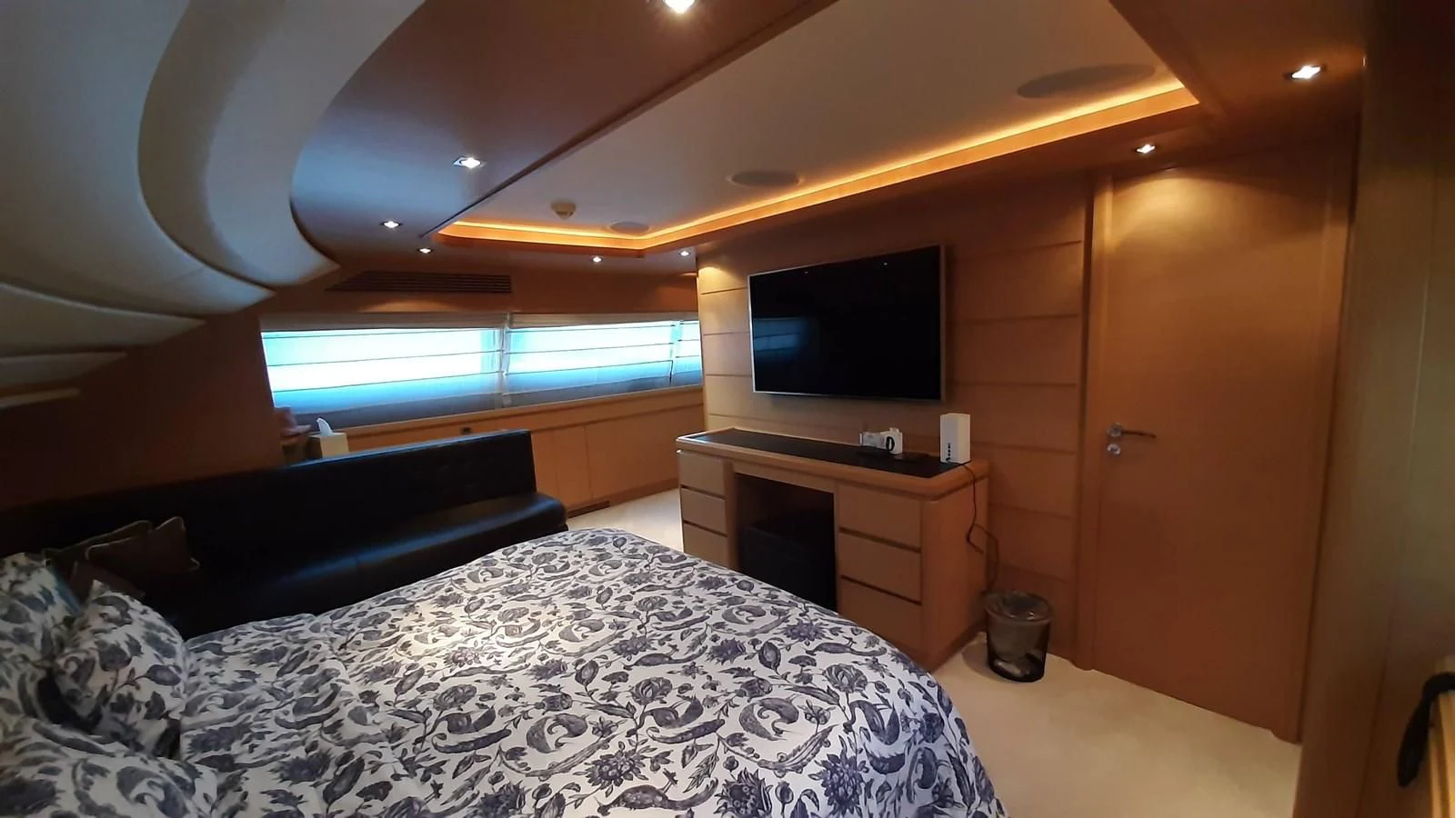 a bedroom with a bed and a tv aboard OKAMI Yacht for Sale