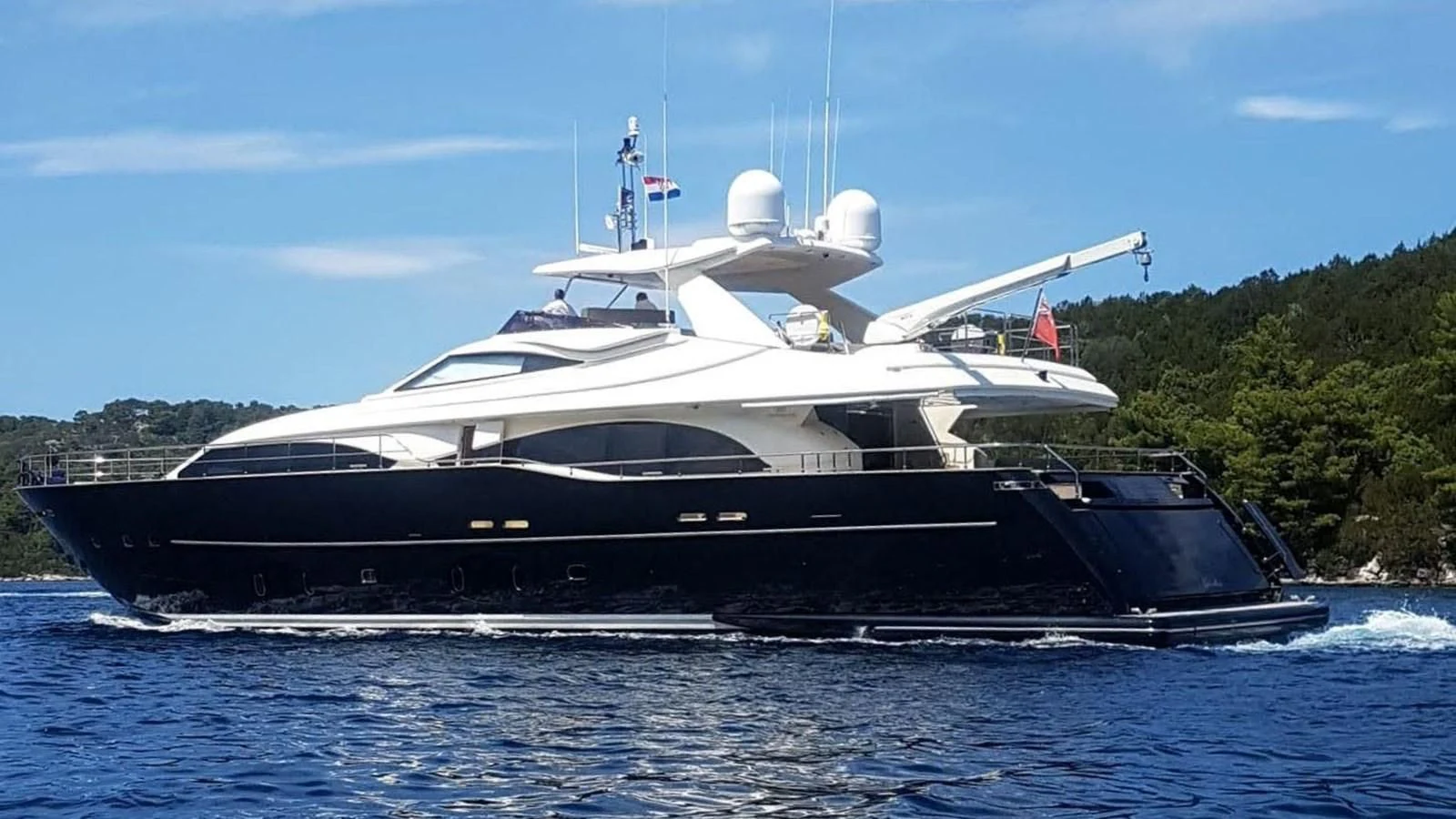 a large boat on the water aboard OKAMI Yacht for Sale