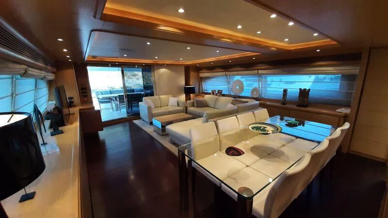 a room with a table and chairs aboard OKAMI Yacht for Sale