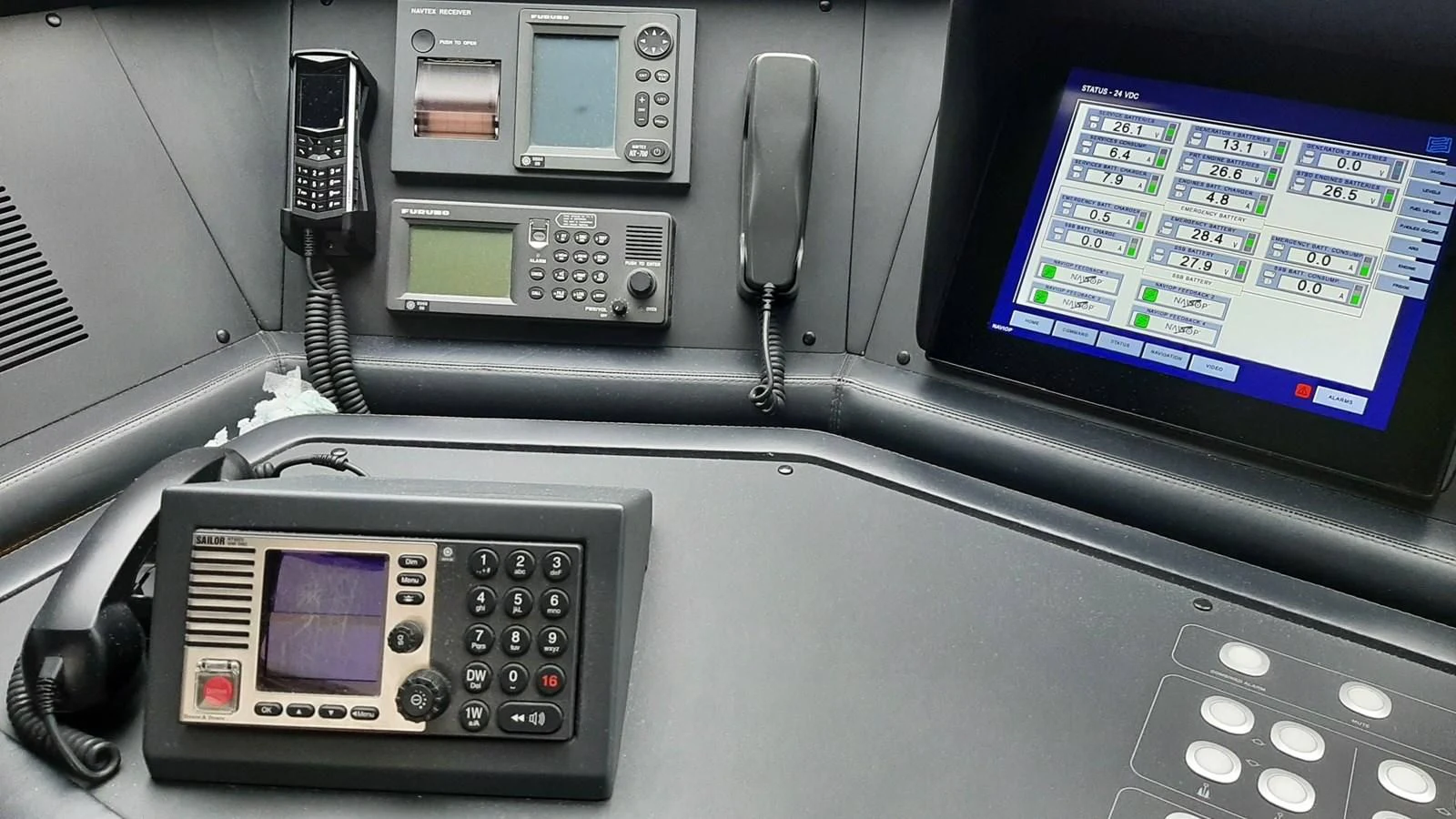 a couple of cell phones on a table aboard OKAMI Yacht for Sale
