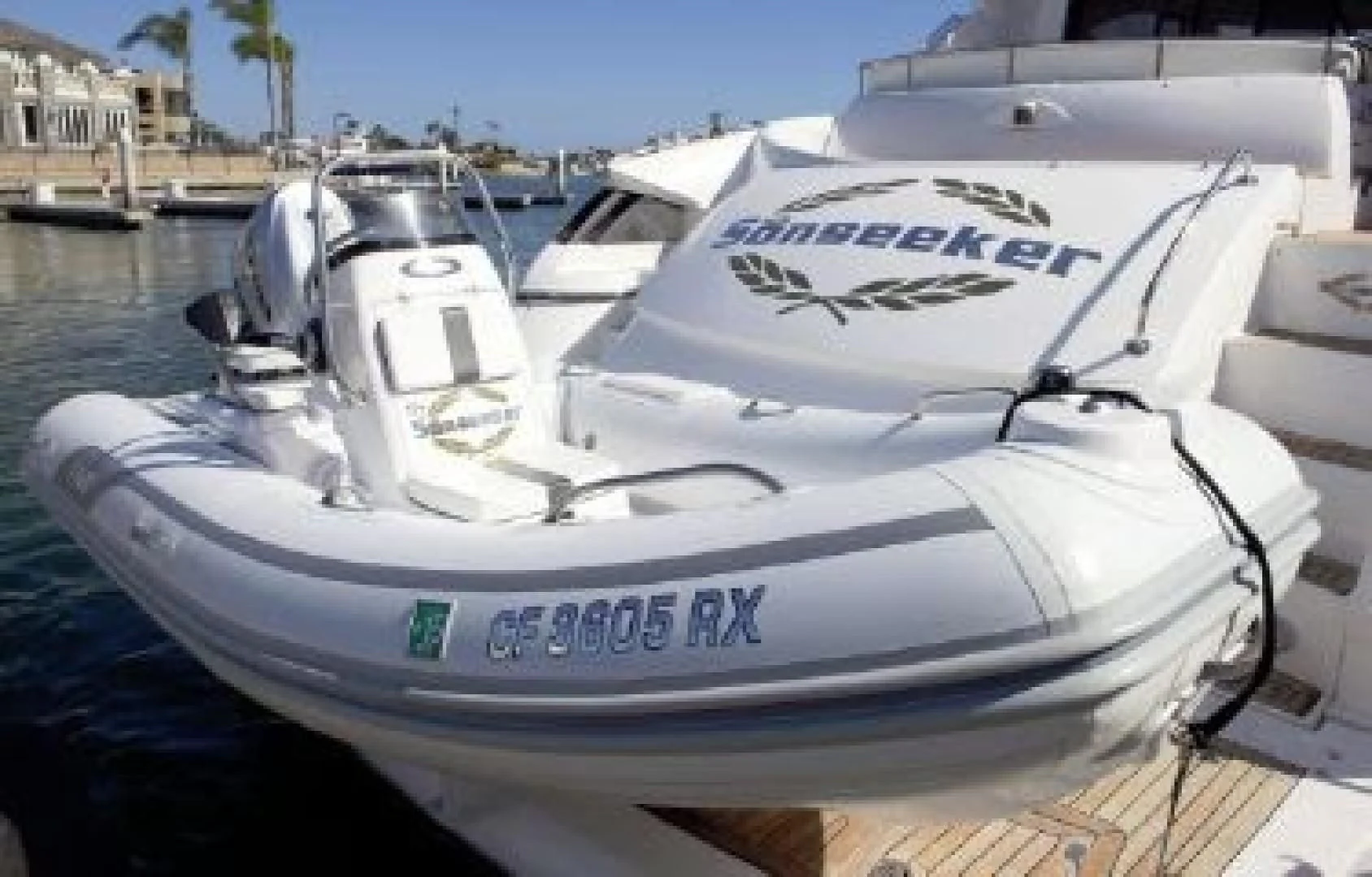 a white boat on a dock aboard SONSEEKER Yacht for Sale