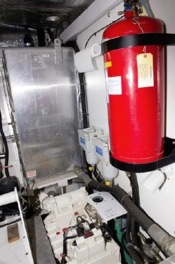 a red and black pipe in a room with other machinery aboard SONSEEKER Yacht for Sale