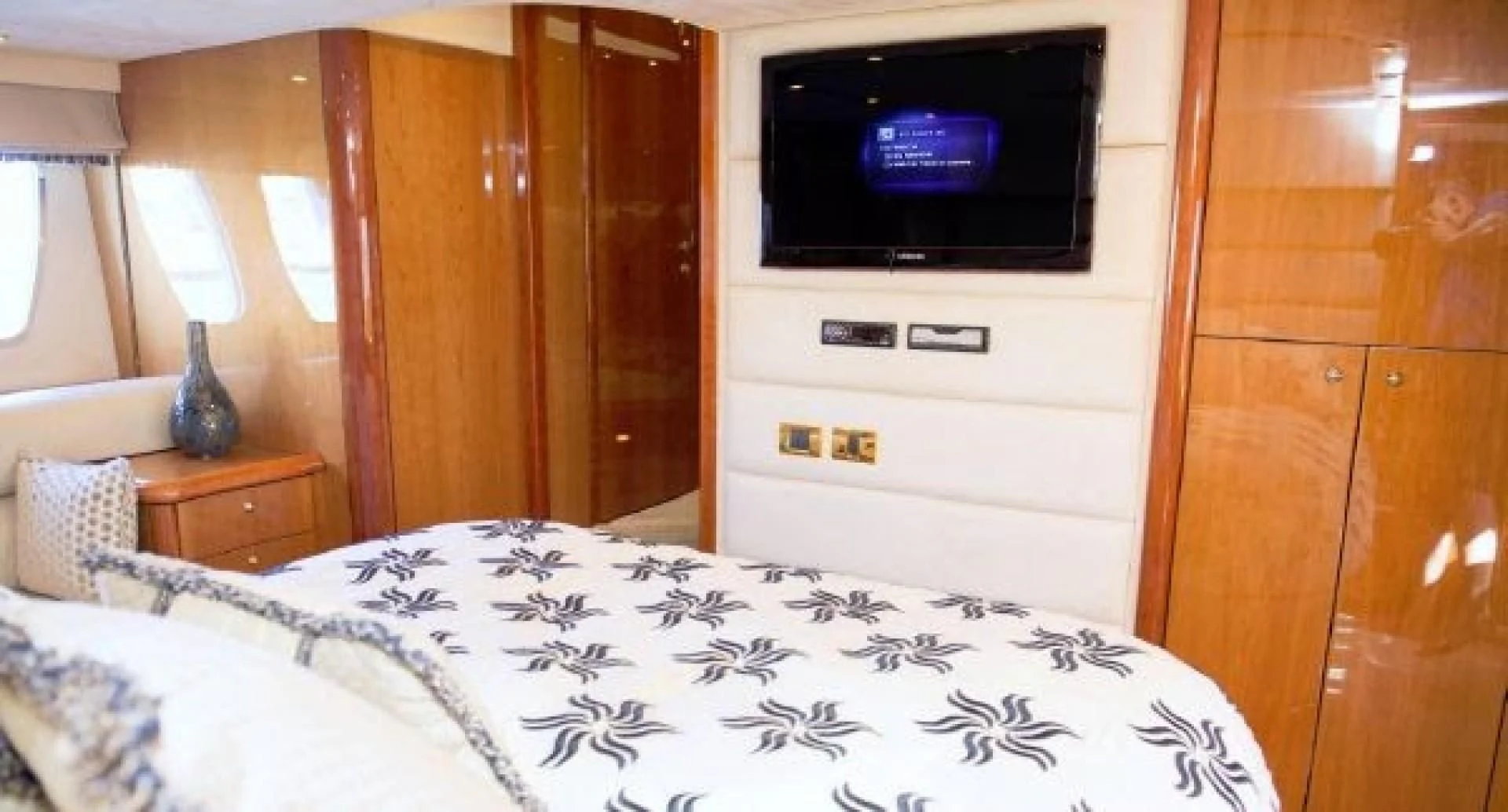 a bedroom with a tv on the wall aboard SONSEEKER Yacht for Sale