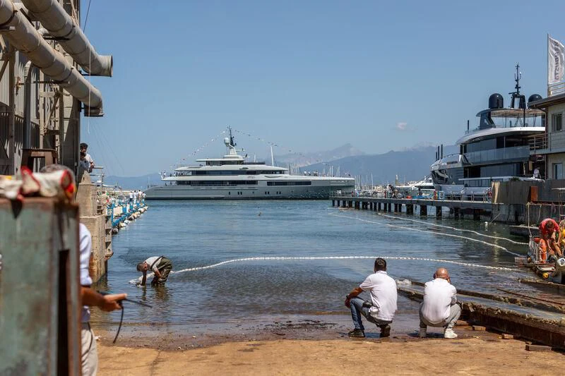 a group of people on a dock looking at a large ship aboard KATHRYN Yacht for Sale