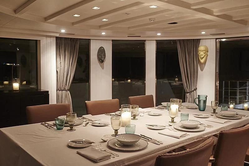 a table set with plates and glasses aboard MENORCA Yacht for Sale