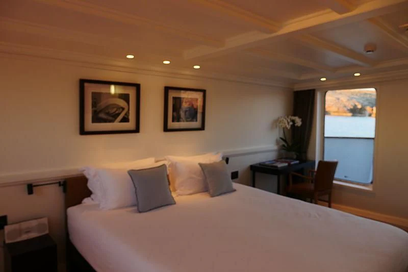 a bed with white sheets and pillows aboard MENORCA Yacht for Sale