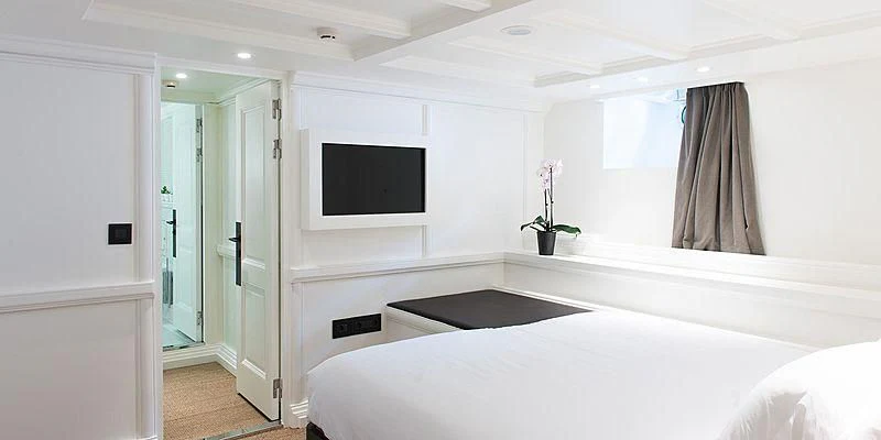 a room with a bed and a television aboard MENORCA Yacht for Sale