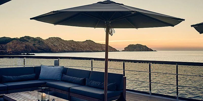 a lounge chair under an umbrella on a boat aboard MENORCA Yacht for Sale