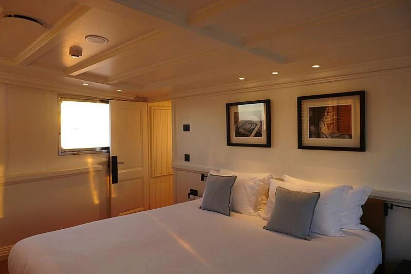 a bed with white sheets and pillows aboard MENORCA Yacht for Sale