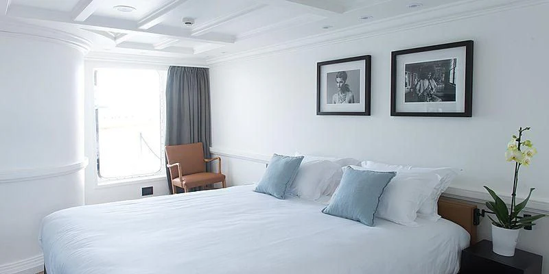 a bed with white sheets and pillows aboard MENORCA Yacht for Sale