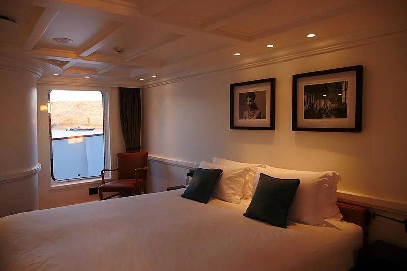 a bed with a white sheet and pillows on it aboard MENORCA Yacht for Sale