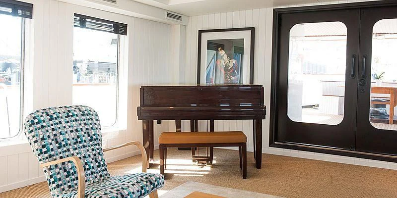 a room with a piano and a chair aboard MENORCA Yacht for Sale