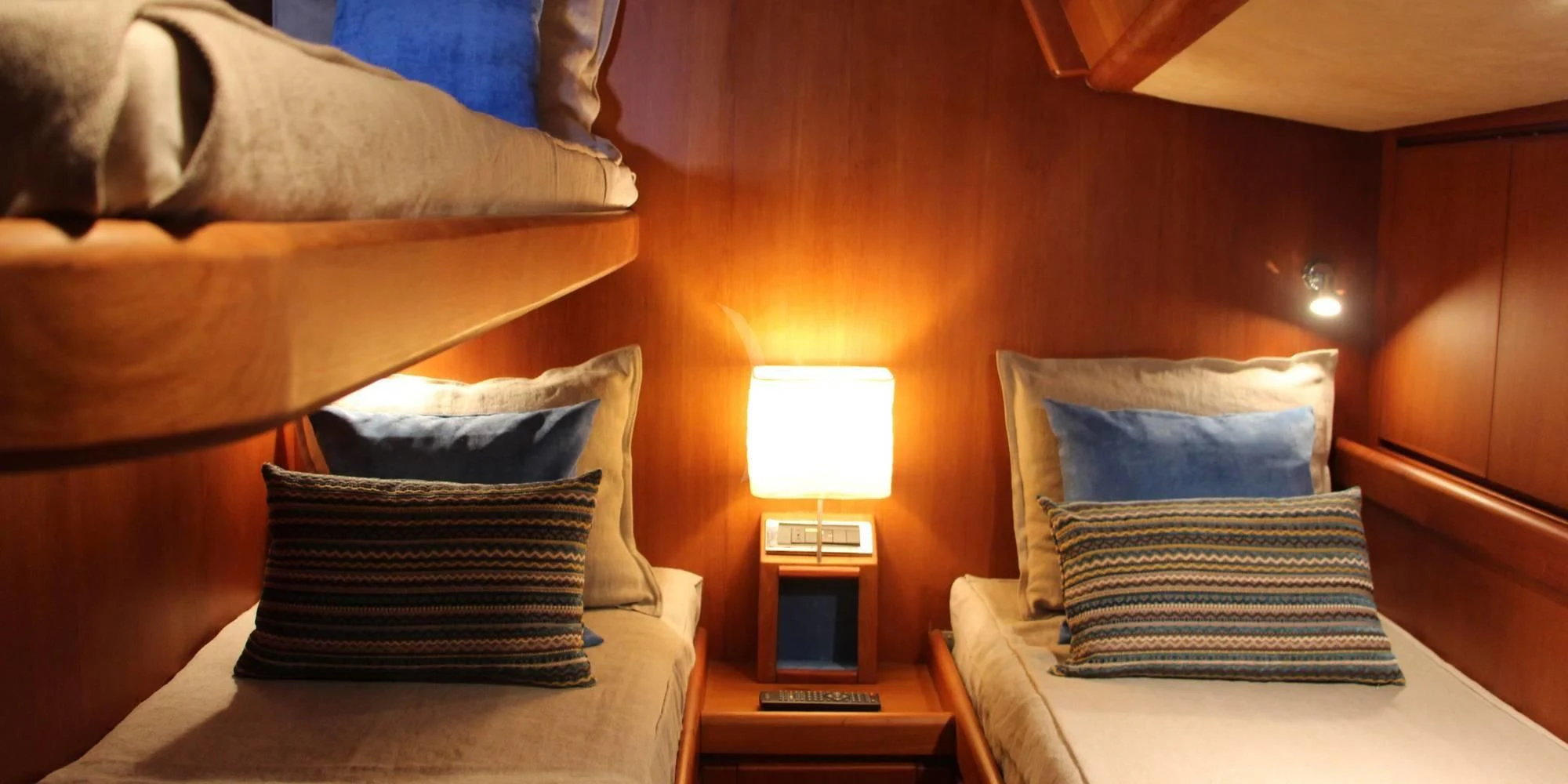 a bed with pillows and a lamp aboard WALLY ONE Yacht for Sale