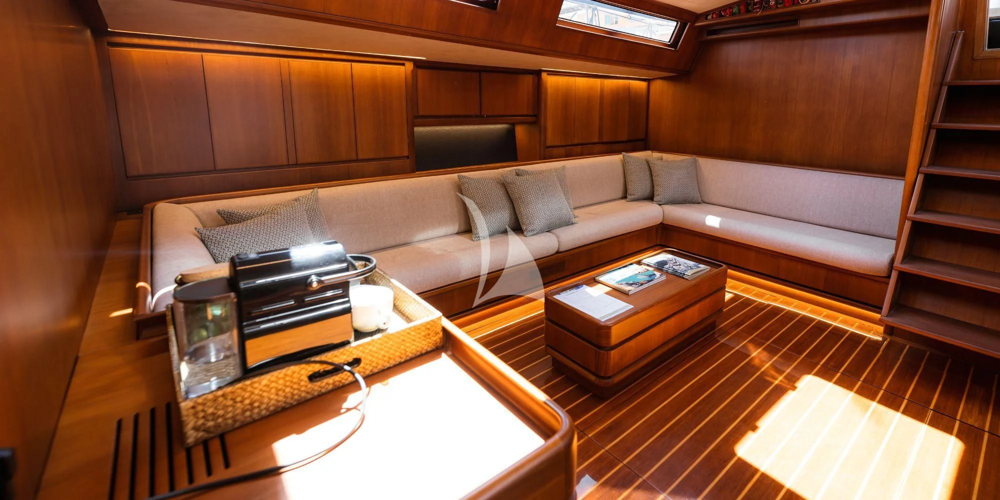 a living room with a couch and coffee table aboard WALLY ONE Yacht for Sale