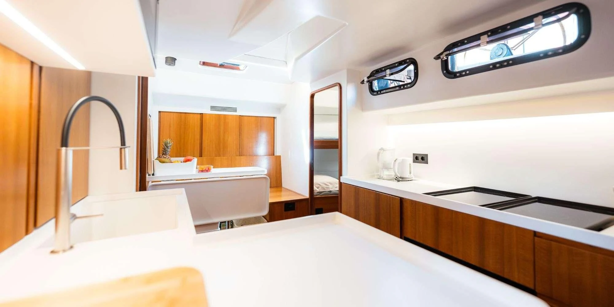 a large kitchen with white counter tops aboard WALLY ONE Yacht for Sale
