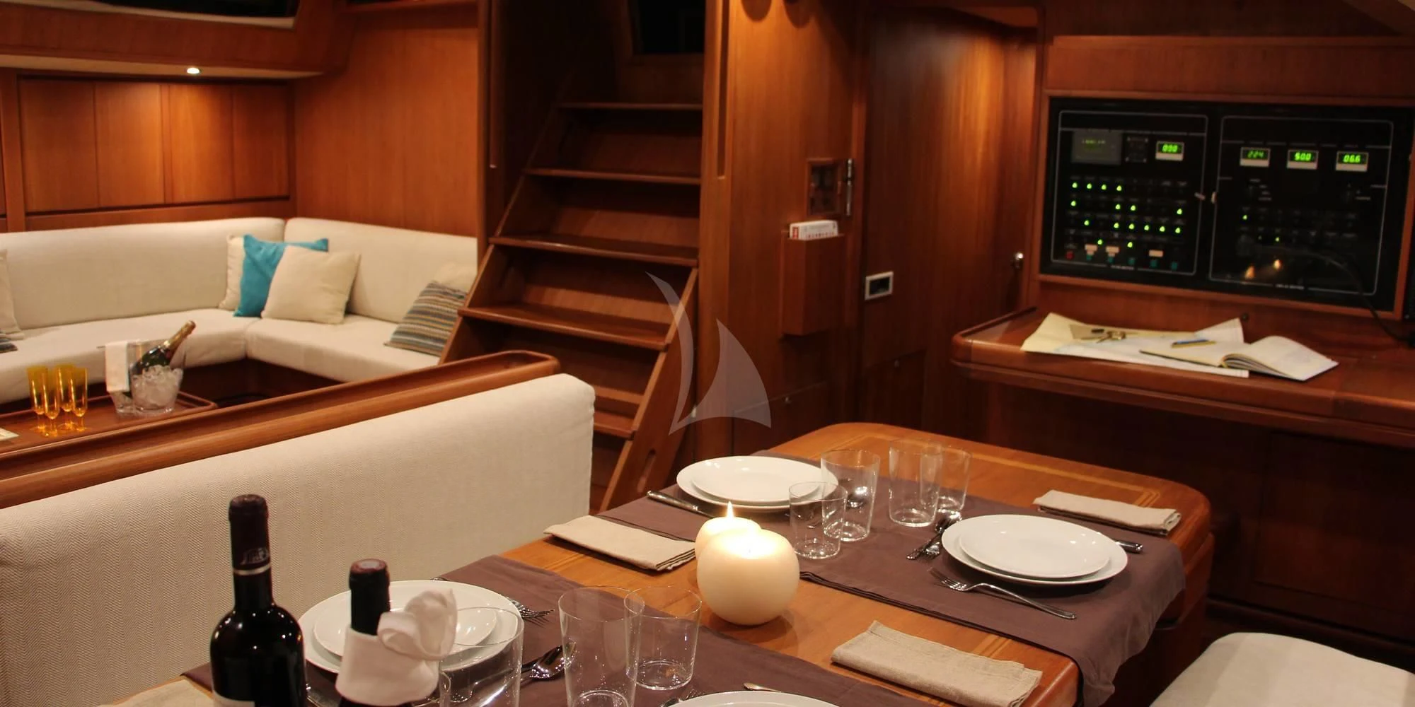 a table with wine glasses and plates on it aboard WALLY ONE Yacht for Sale