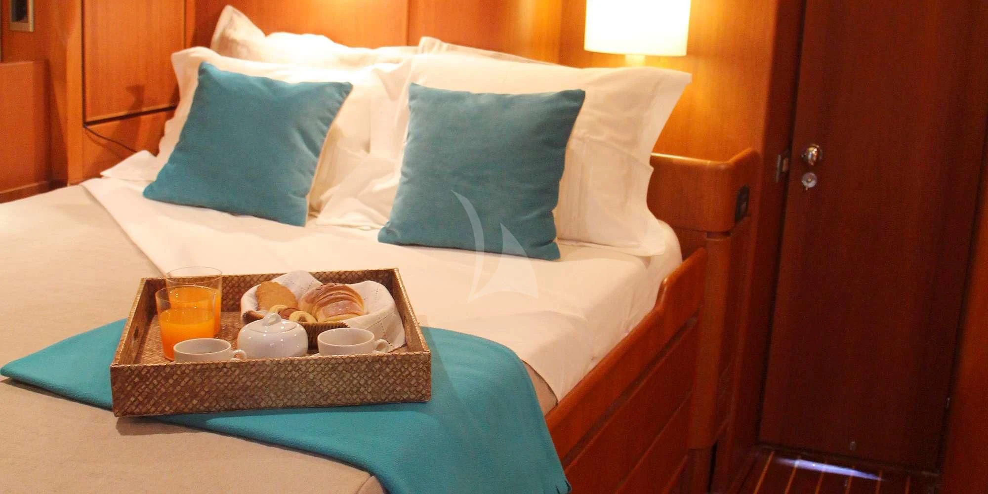 a bed with a tray of food aboard WALLY ONE Yacht for Sale
