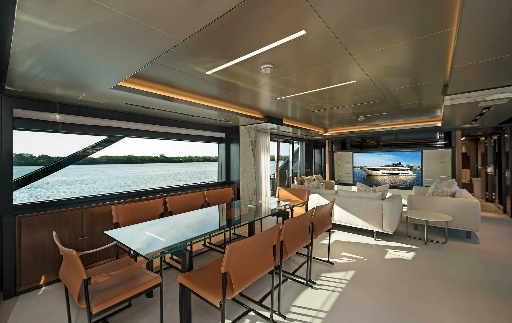 a room with a table chairs and a large window aboard ALEGRA Yacht for Sale