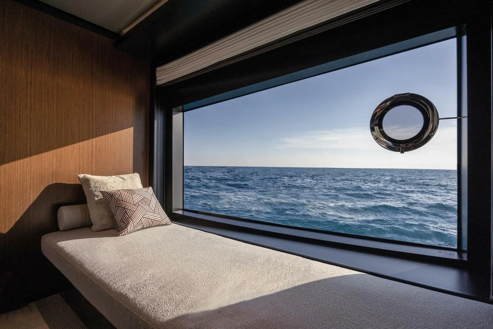 a bed next to a window aboard ALEGRA Yacht for Sale