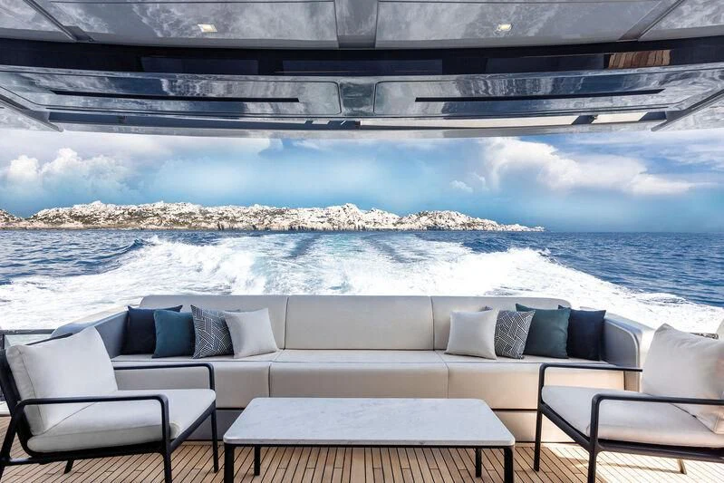 a large white couch and chairs on a balcony overlooking a body of water aboard ALEGRA Yacht for Sale