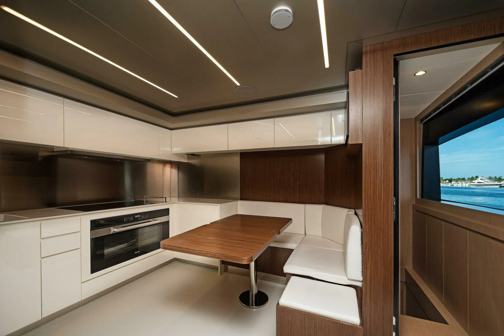 a kitchen with a table and chairs aboard ALEGRA Yacht for Sale
