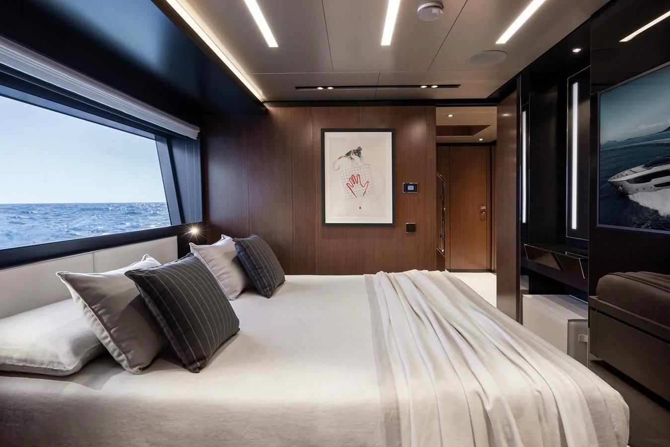 a bed with pillows and a window aboard ALEGRA Yacht for Sale