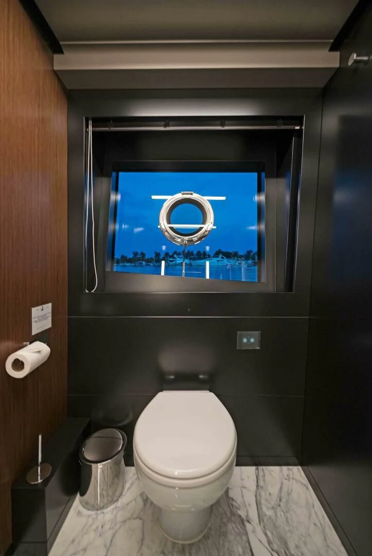 a bathroom with a blue framed mirror aboard ALEGRA Yacht for Sale