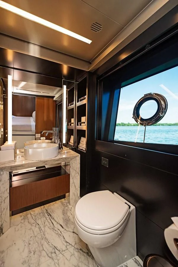 a bathroom with a sink toilet and a window aboard ALEGRA Yacht for Sale