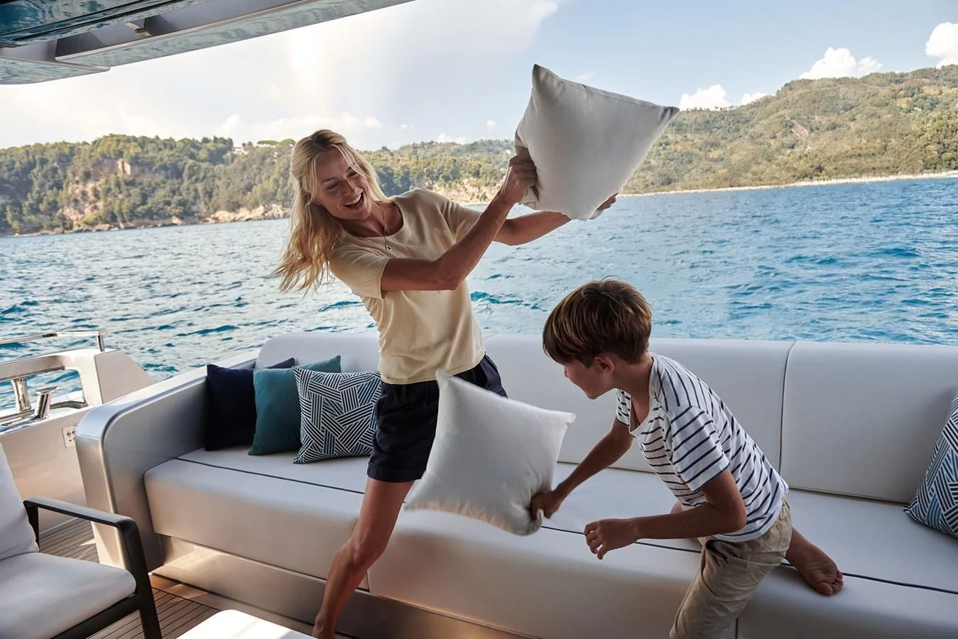 a person and a boy on a couch by a body of water aboard ALEGRA Yacht for Sale