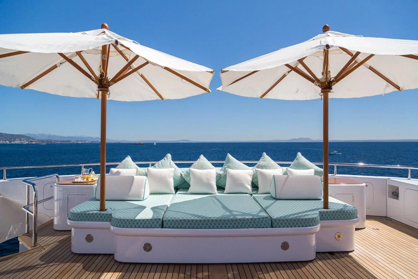 a bed and umbrella on a deck aboard NECTAR Yacht for Sale