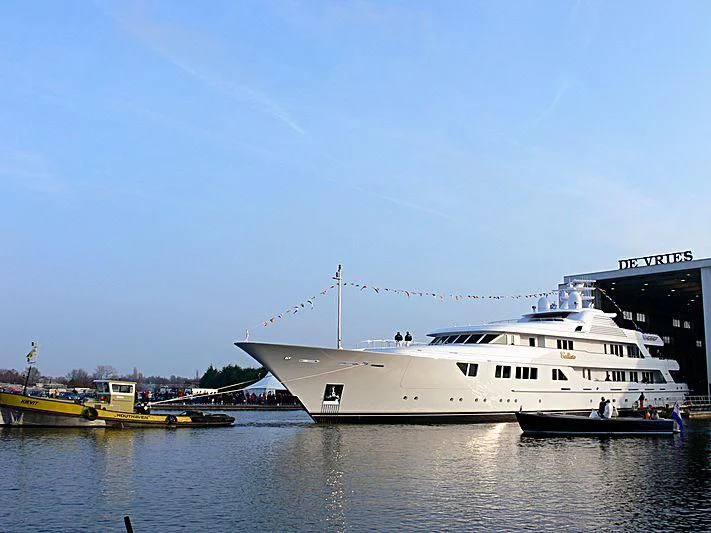 a large white boat in a harbor aboard NECTAR Yacht for Sale