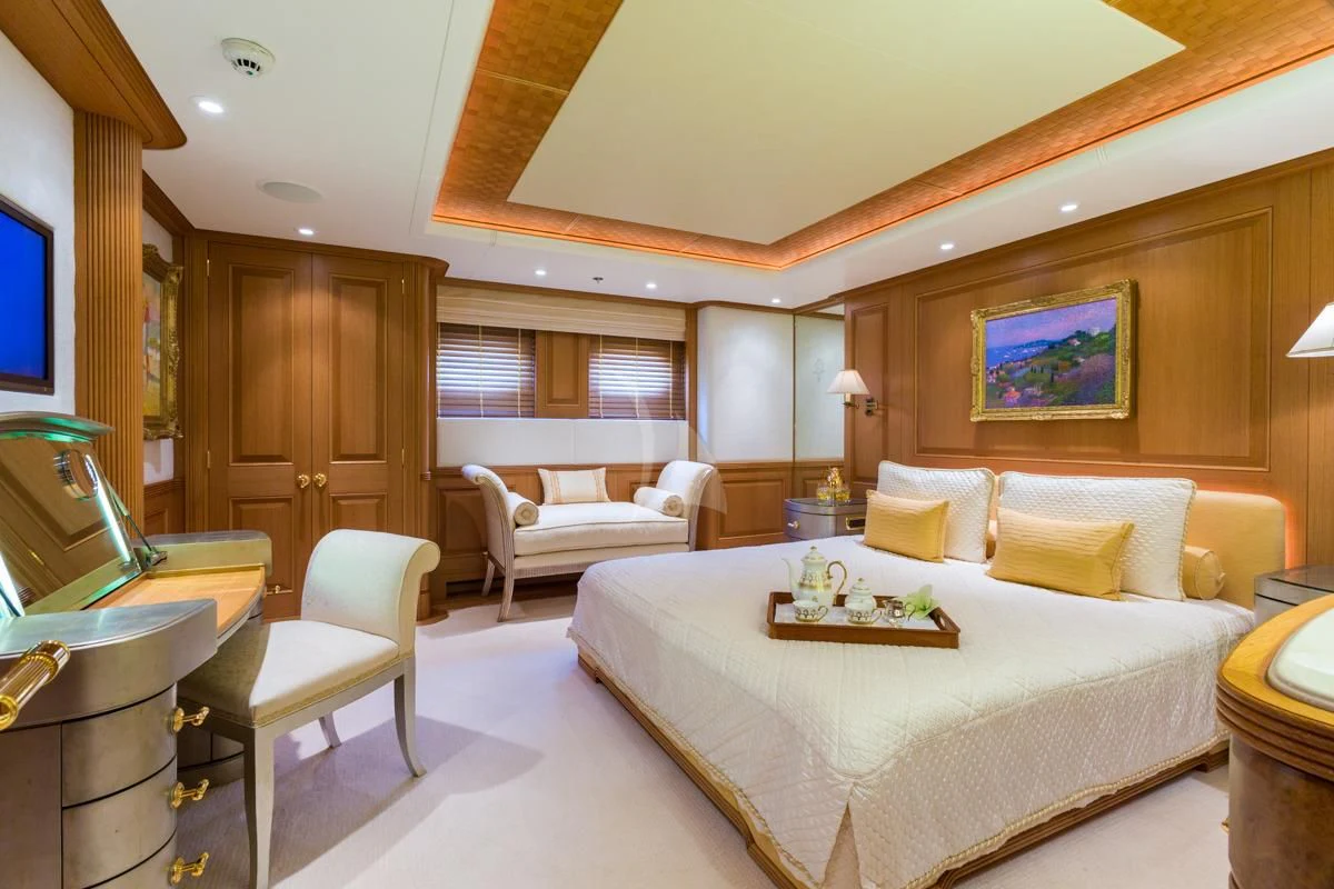a large bedroom with a bed and a couch aboard NECTAR Yacht for Sale