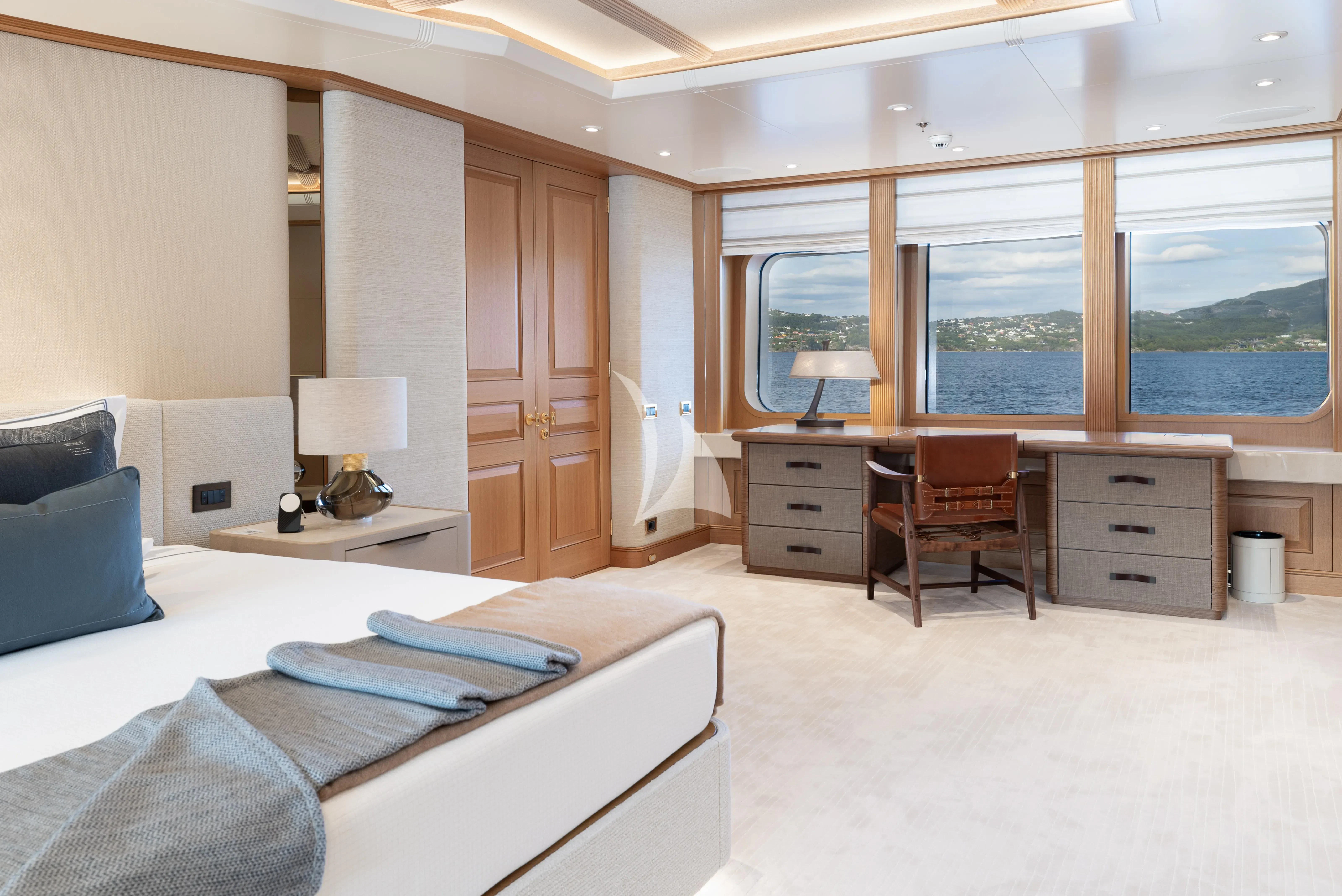 a bedroom with a bed and a desk aboard NECTAR Yacht for Sale