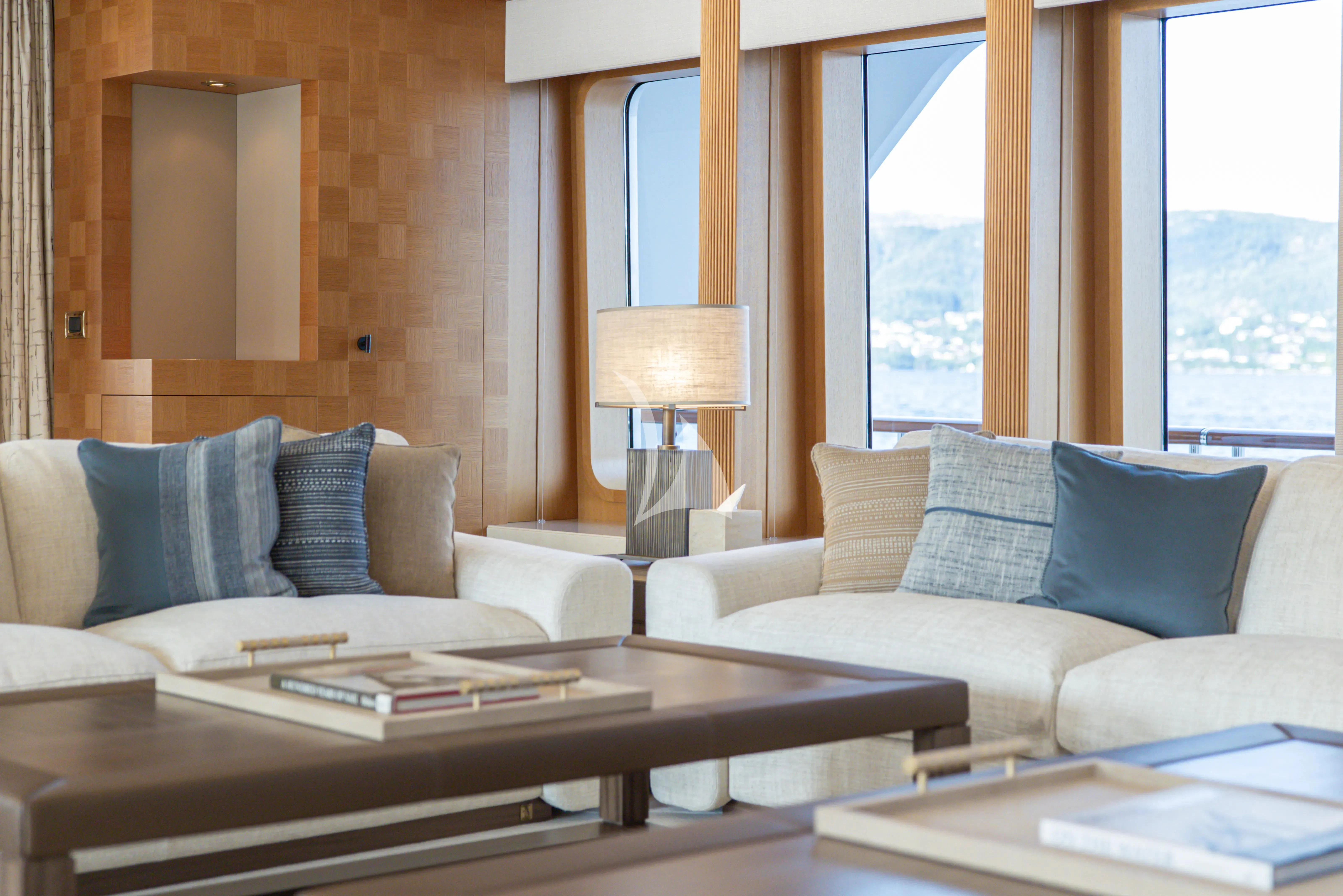 a living room with a couch and a coffee table aboard NECTAR Yacht for Sale