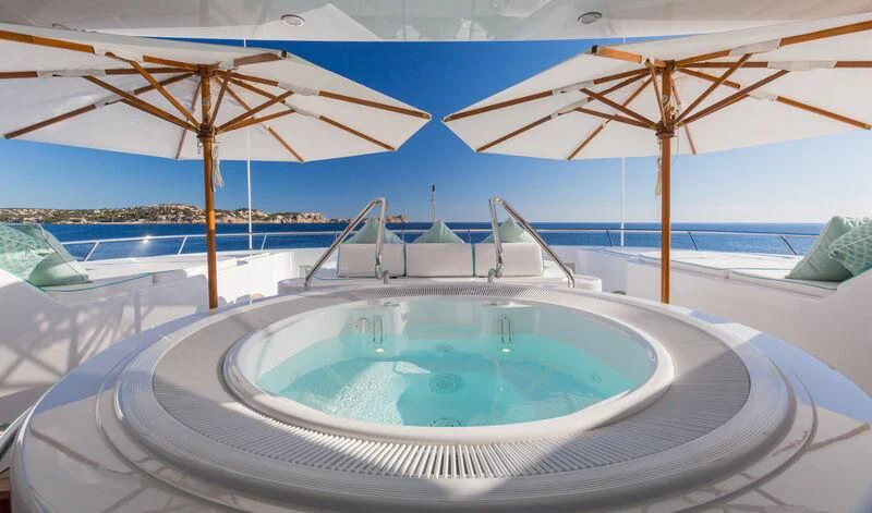 a pool with umbrellas aboard NECTAR Yacht for Sale