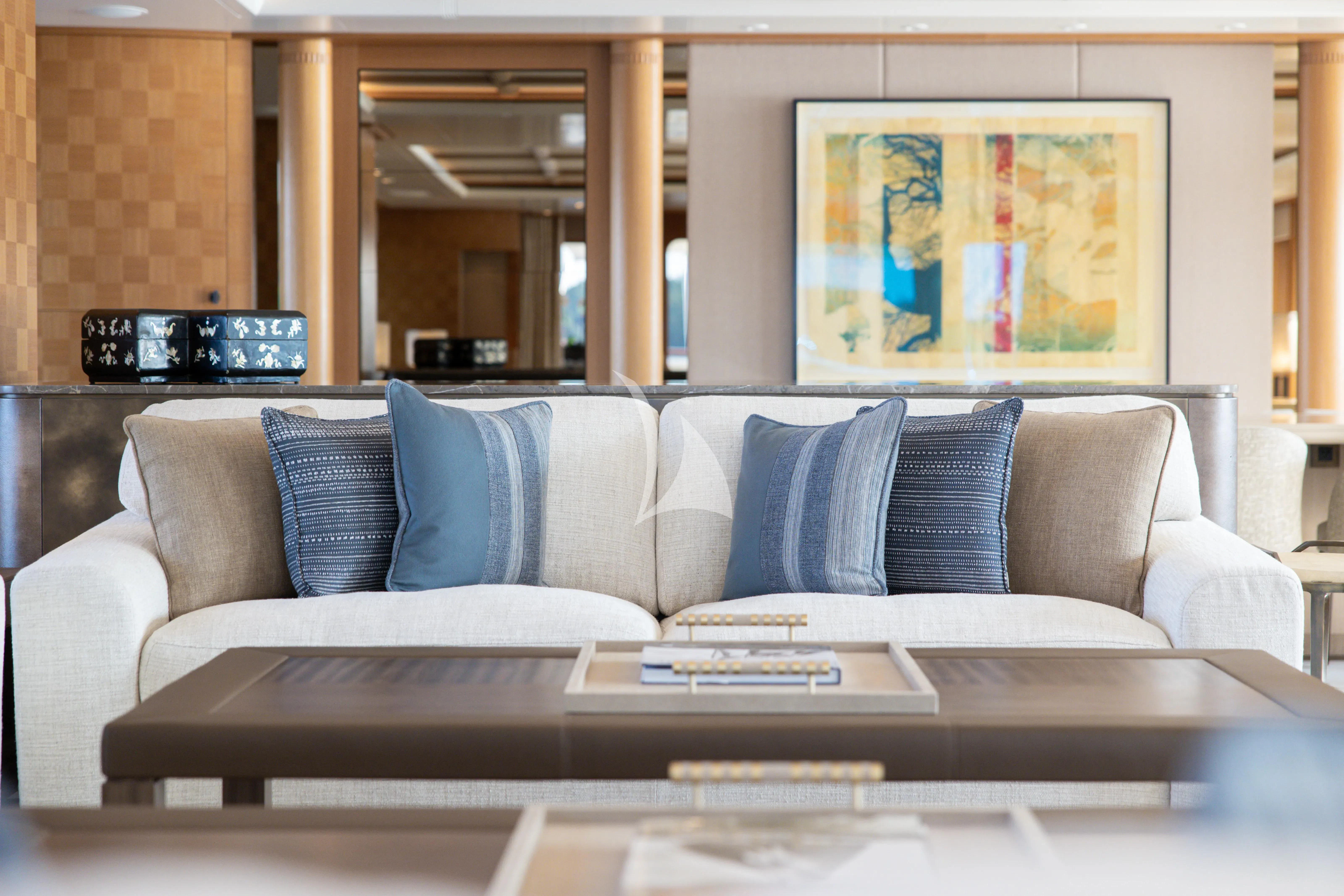 a couch with a coffee table in front of it aboard NECTAR Yacht for Sale