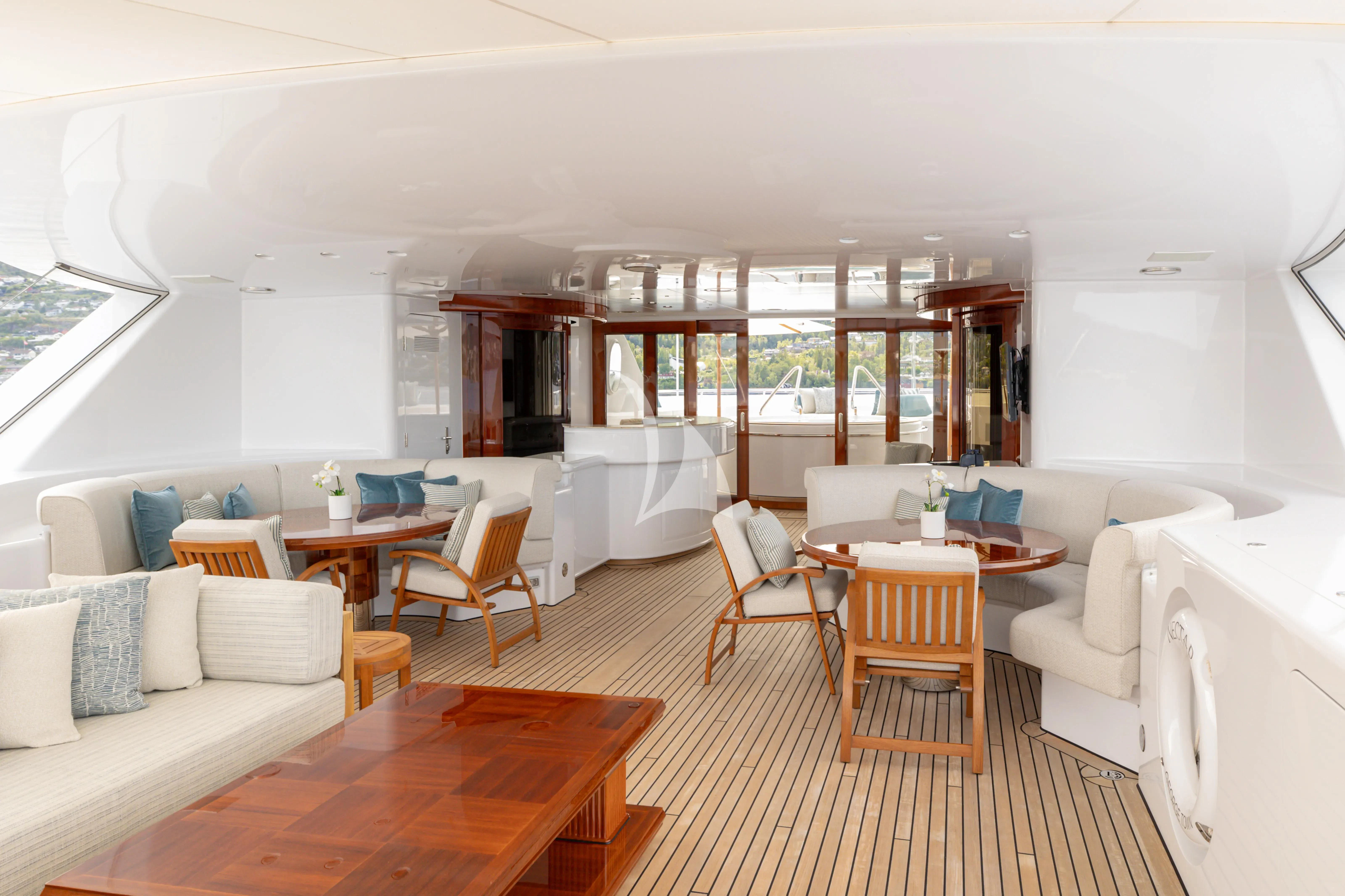 a living room with a table and chairs aboard NECTAR Yacht for Sale