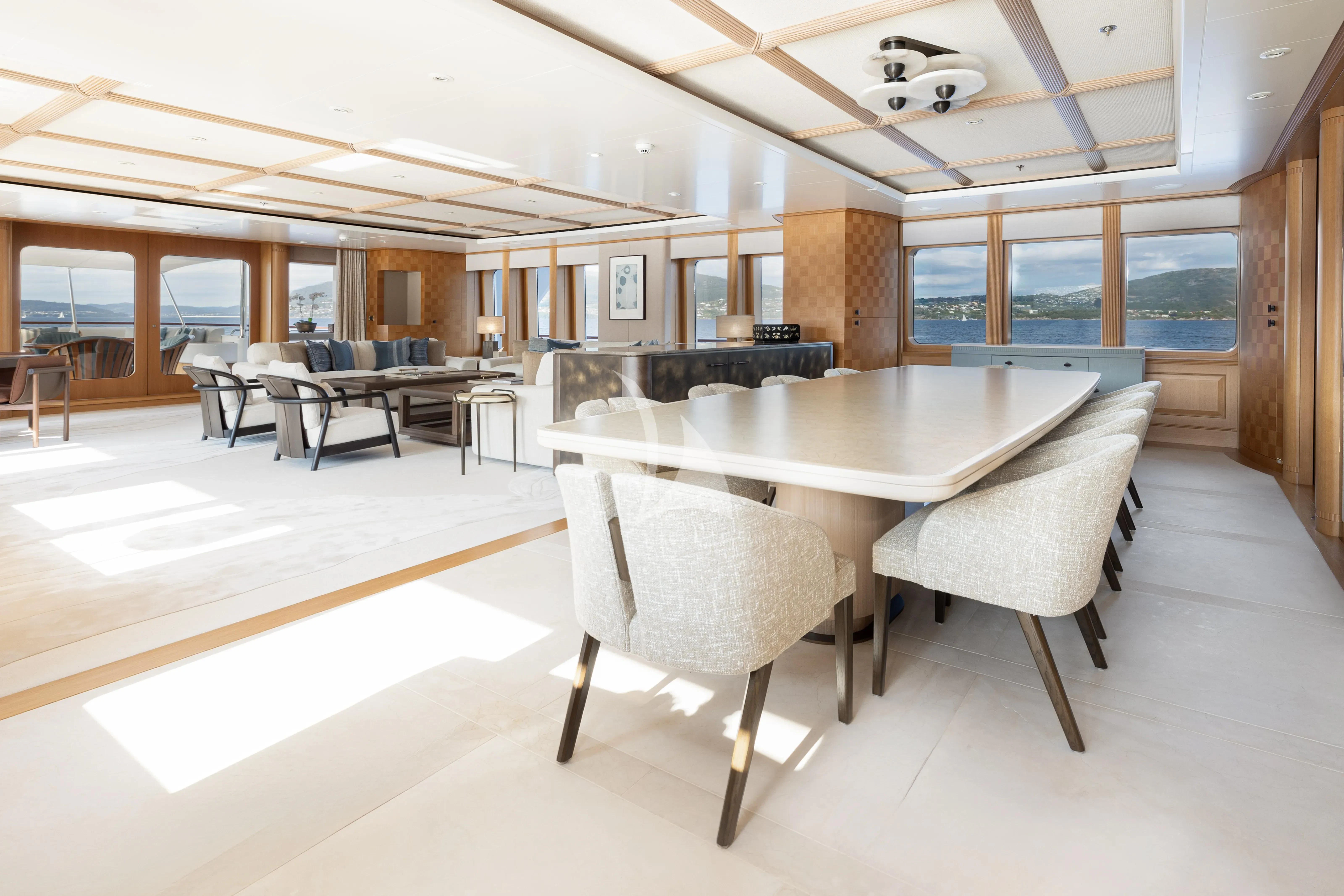 a large room with a table and chairs aboard NECTAR Yacht for Sale