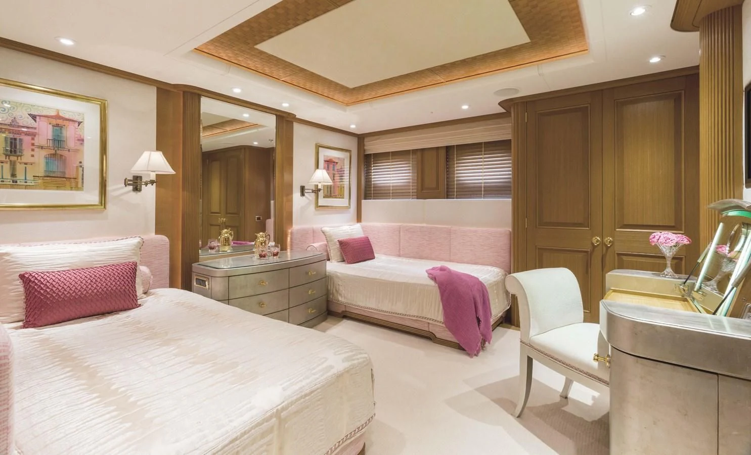a bedroom with a bed and a chair aboard NECTAR Yacht for Sale