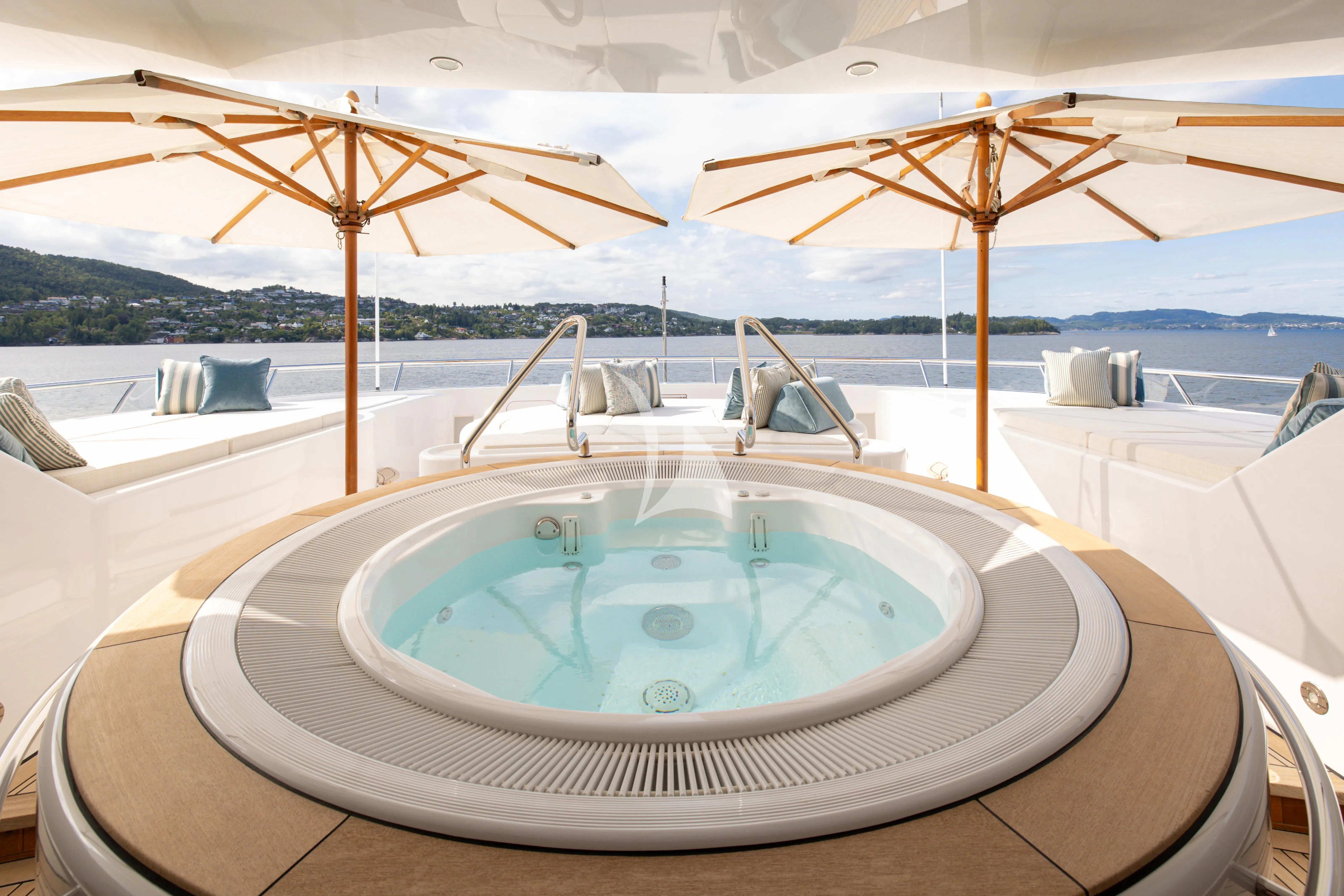 a pool with umbrellas aboard NECTAR Yacht for Sale