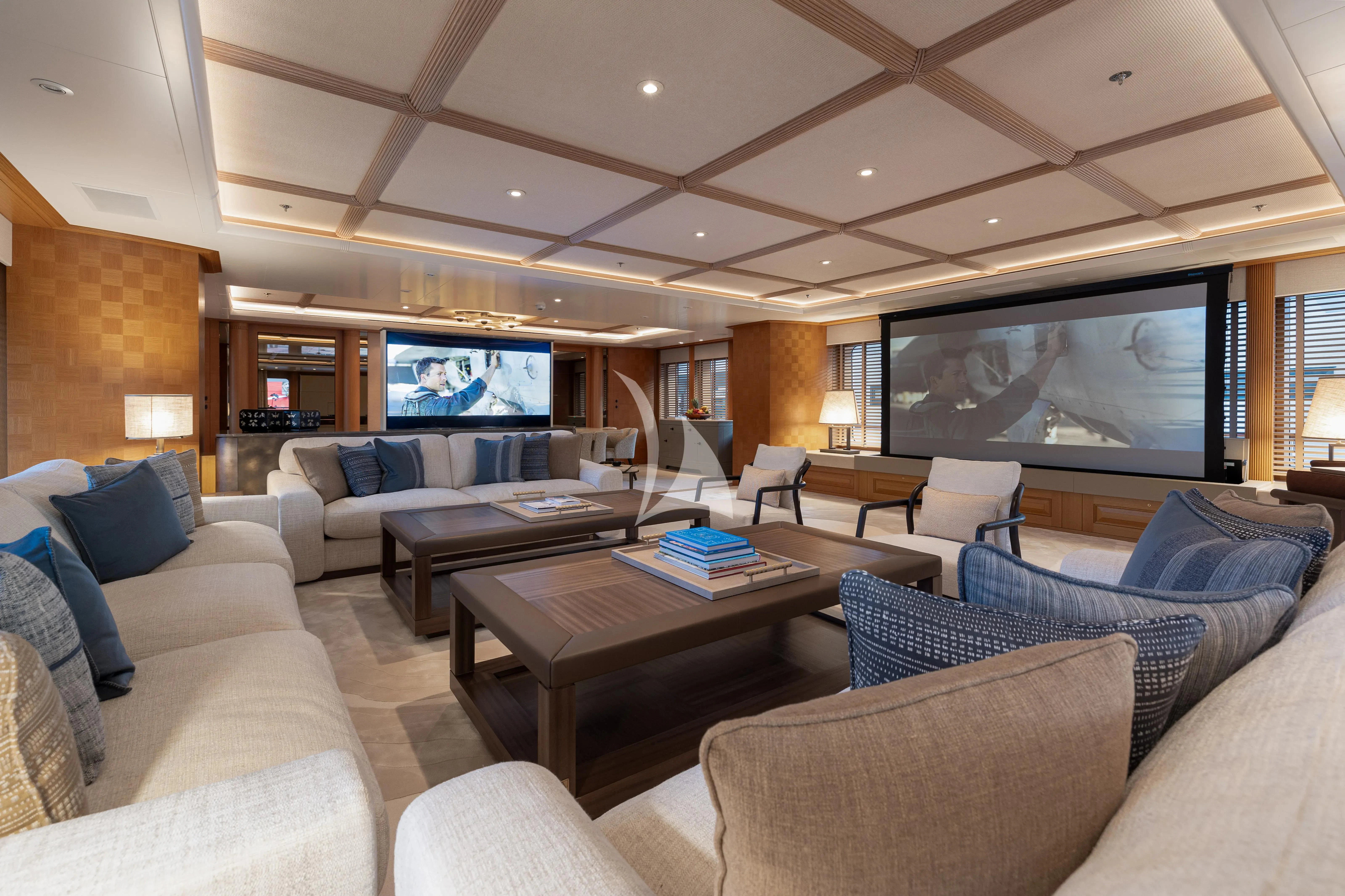 a living room with a large screen aboard NECTAR Yacht for Sale