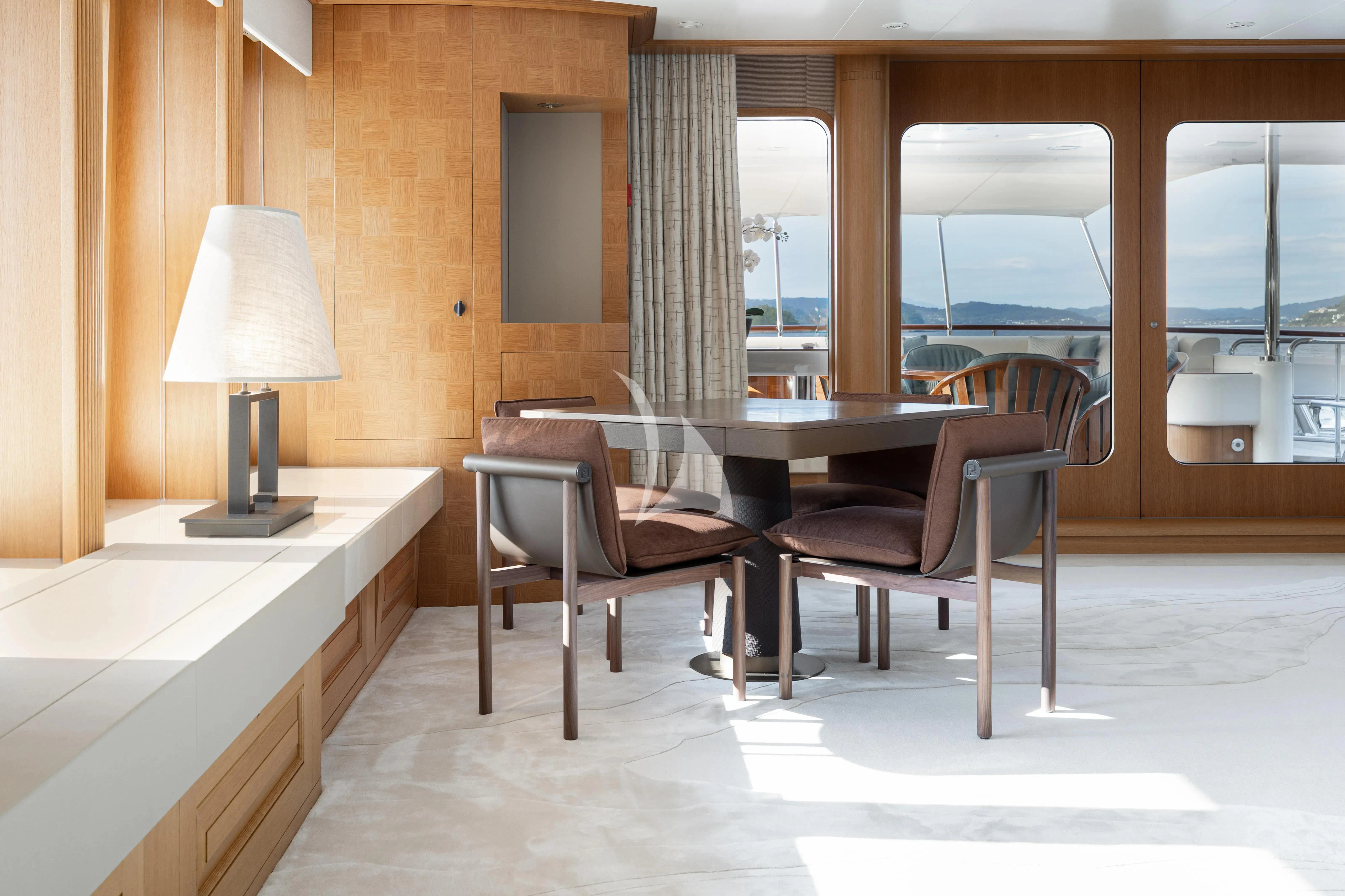 a room with a table and chairs aboard NECTAR Yacht for Sale