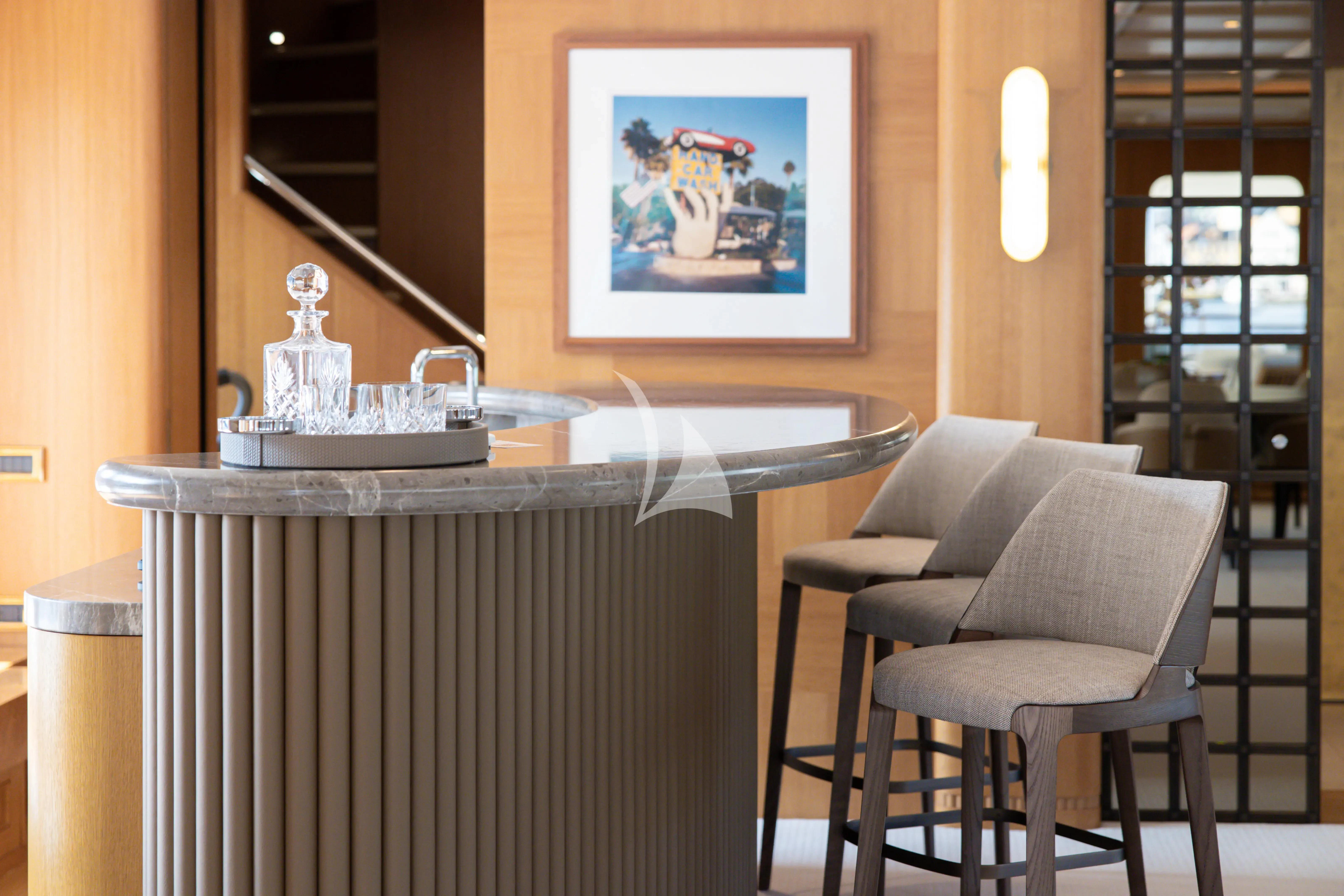 a table with a chair and a lamp on it aboard NECTAR Yacht for Sale