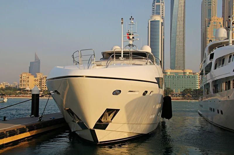 a white boat docked at a pier aboard SIA Yacht for Sale
